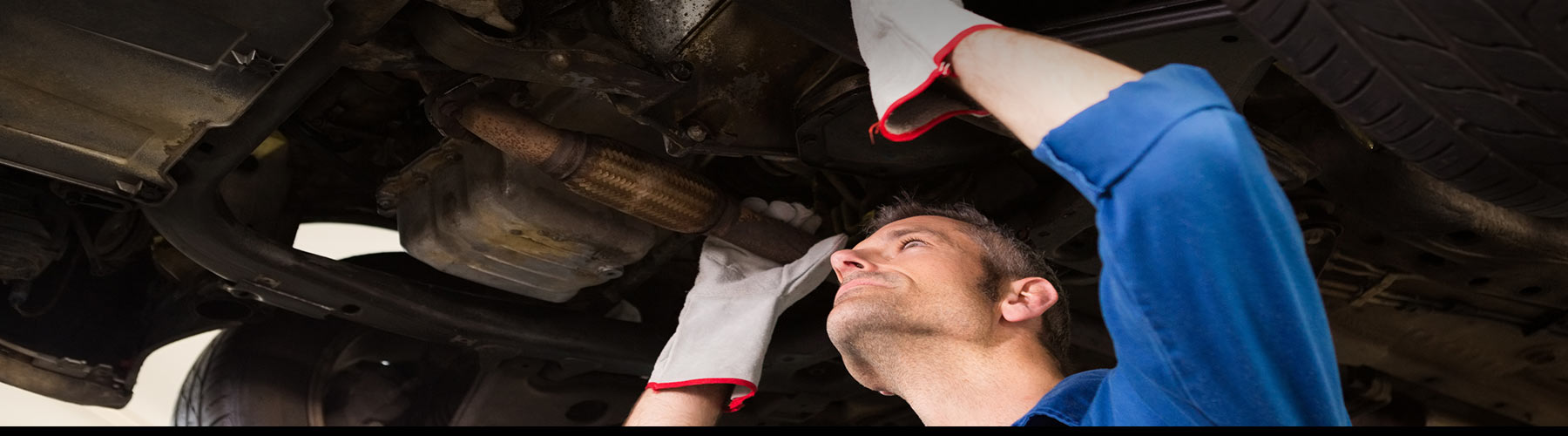 Machanic holding exhaust to repair vehicle